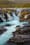 Autumn's Azure Symphony: Iceland's Bruarfoss Waterfall in Seasonal Transformation